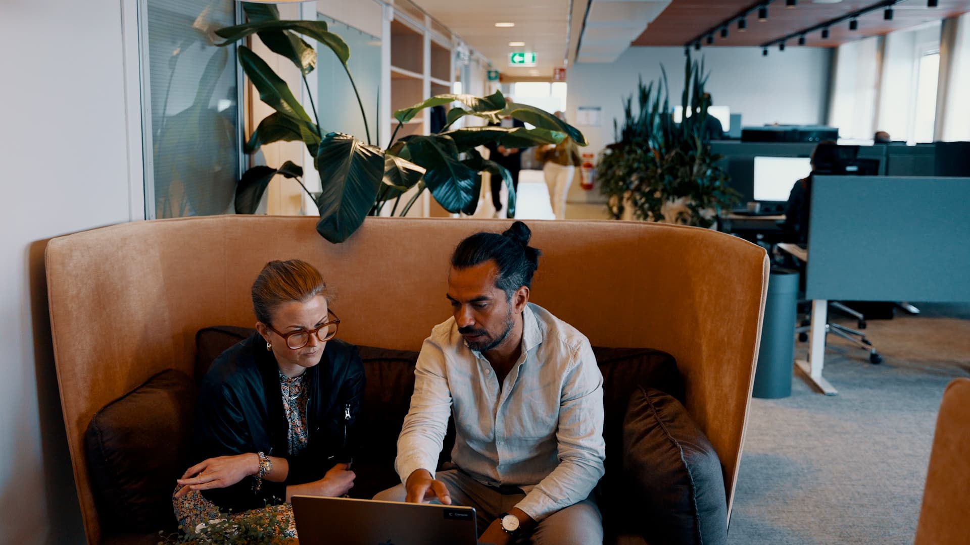 Two professionals collaborating at laptop